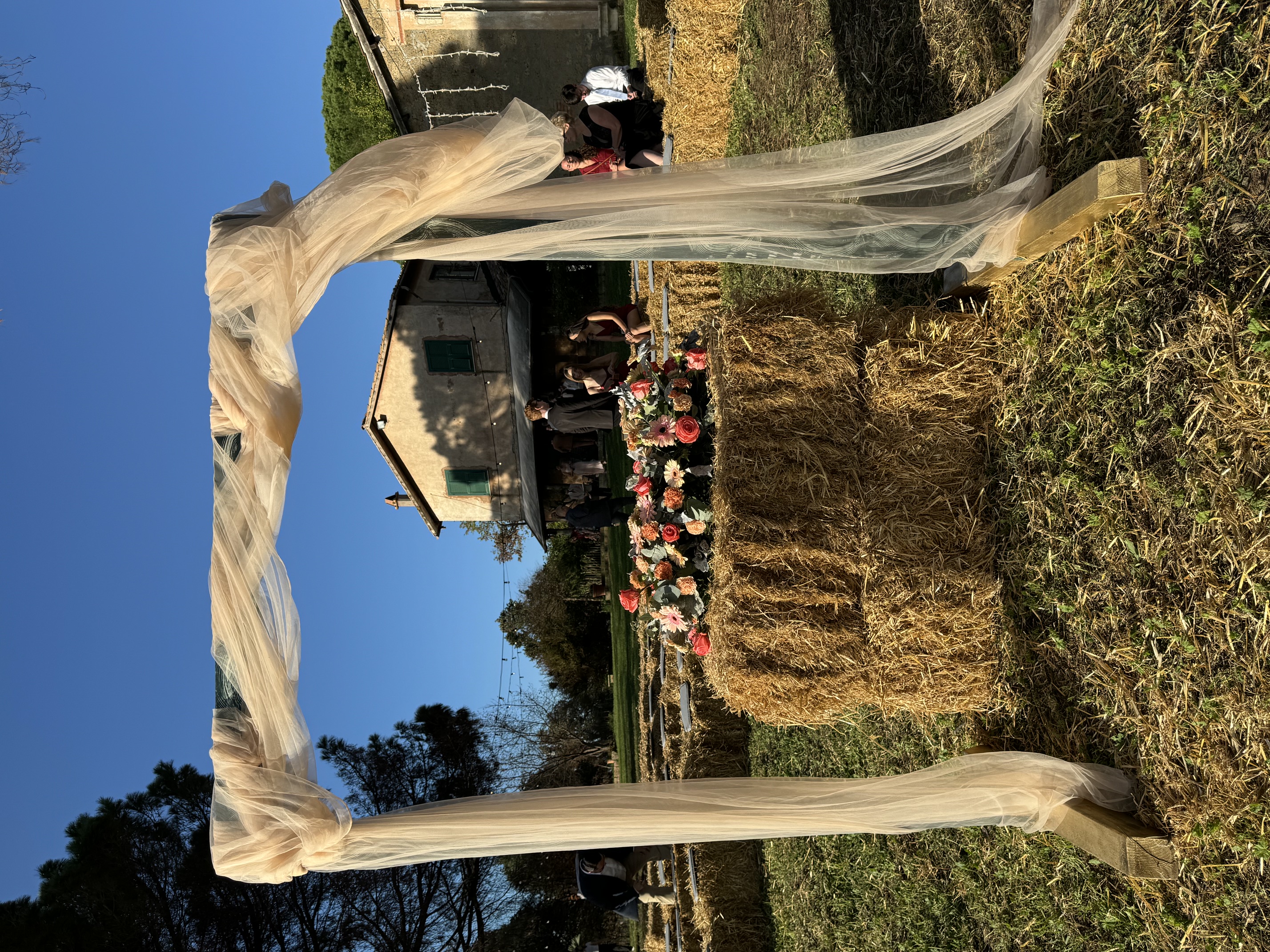 Ceremony arch set up in the yard at golden hour
